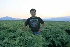 有機無化学農薬で栽培するコンニャク畑に立つ浦澤彰治氏